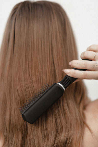 Red head with smooth sculpted hair showing off gentle 9-row brush bristles.